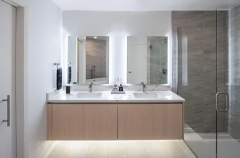 a bathroom with a double vanity sink and mirror