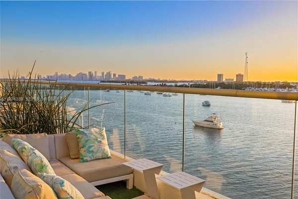 a view of a terrace with sitting space and lake view