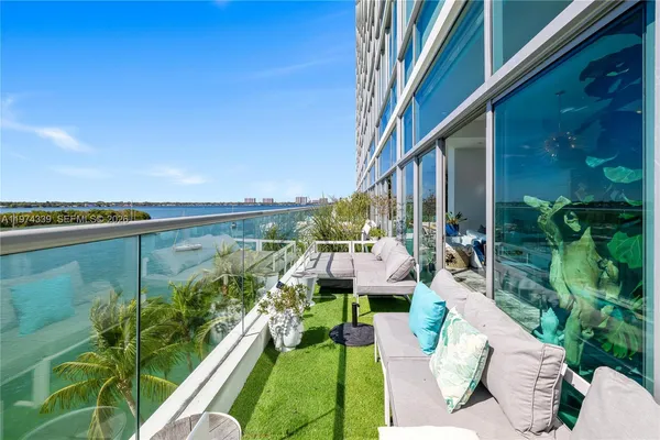 a balcony with couch and wooden floor