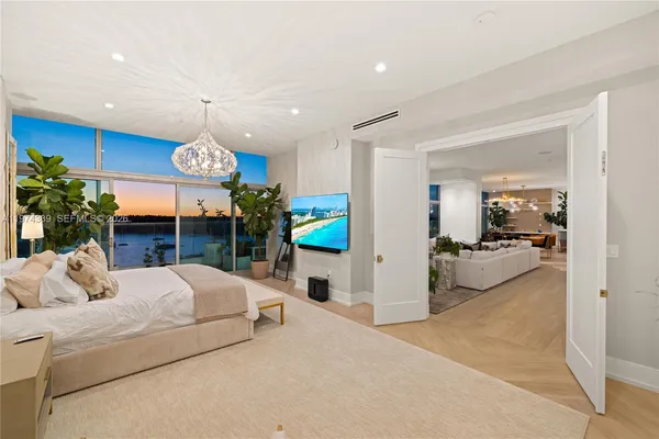 a living room with furniture and a floor to ceiling window
