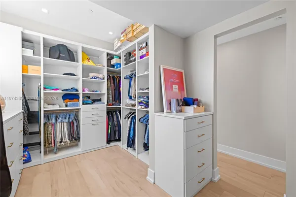 a bedroom with furniture and a large window