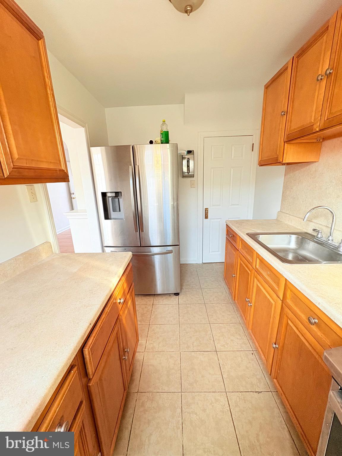 6045 Summerdale Avenue Philadelphia, PA 19149 - Photo 2 of 12 a kitchen with stainless steel appliances granite countertop a sink and a refrigerator