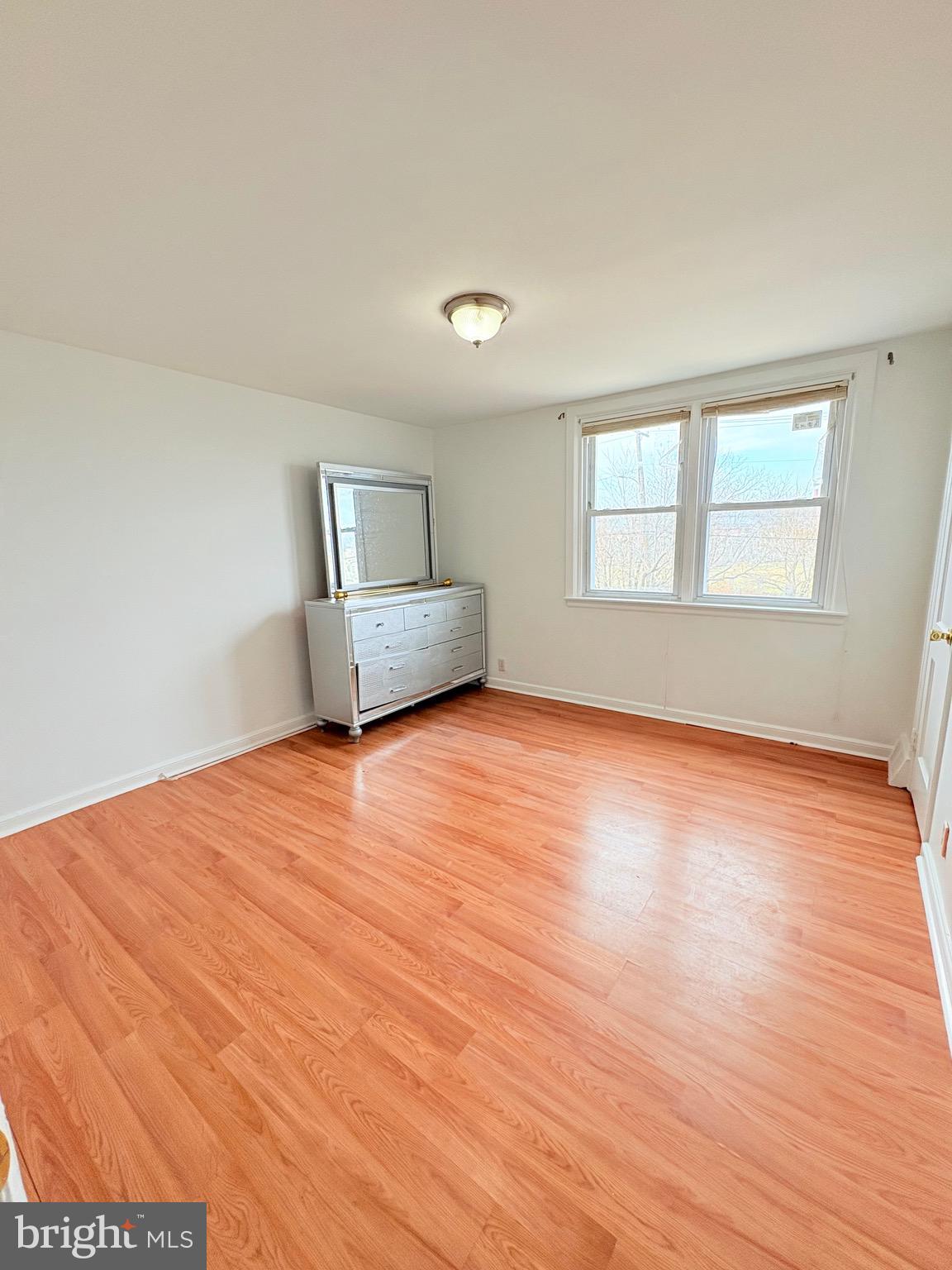 6045 Summerdale Avenue Philadelphia, PA 19149 - Photo 8 of 12 a view of empty room with wooden floor and fan