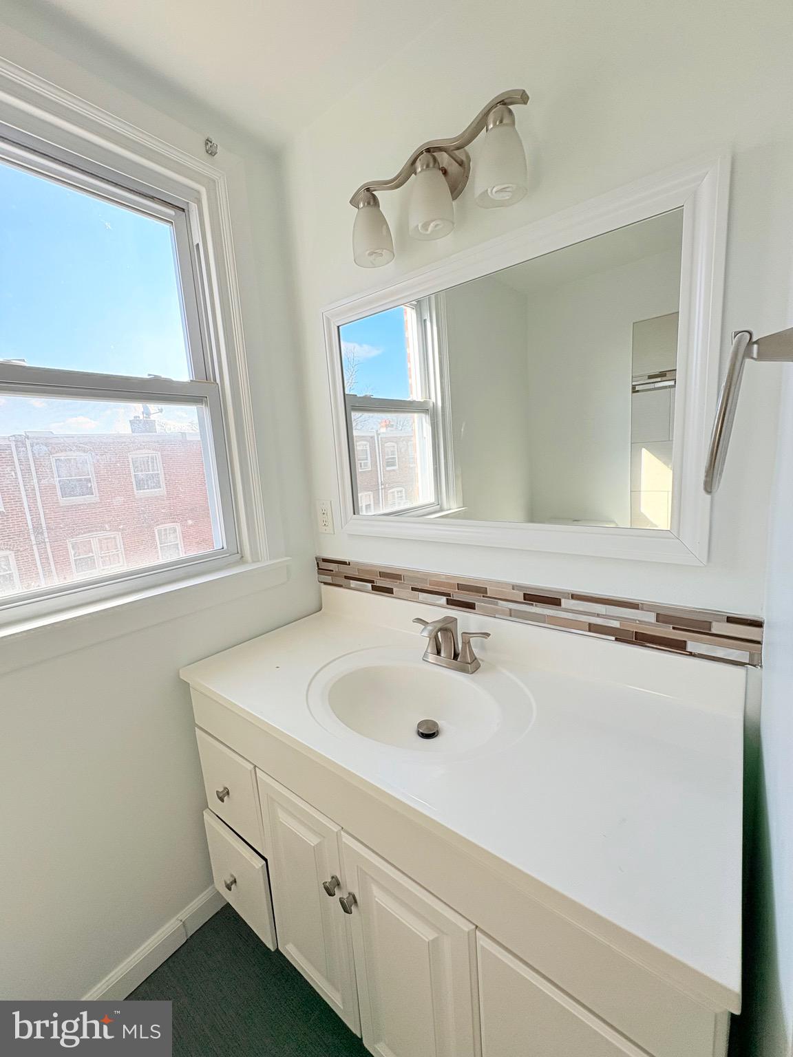6045 Summerdale Avenue Philadelphia, PA 19149 - Photo 10 of 12 a bathroom with a sink and a mirror