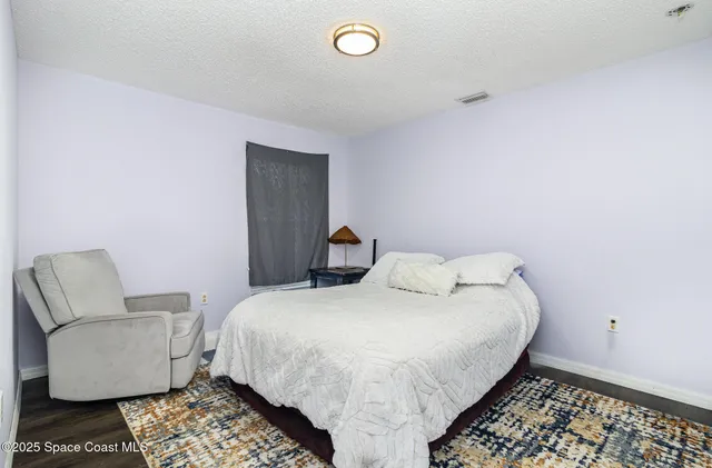 a bedroom with a bed and couch