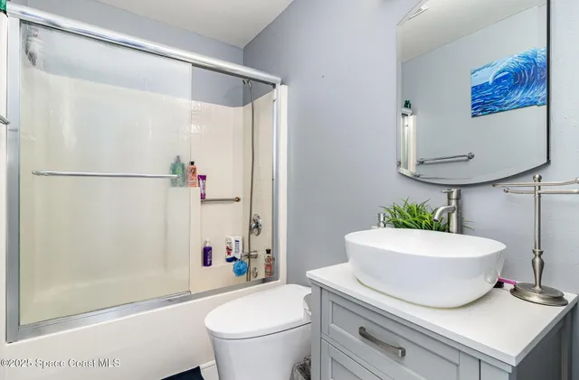 a bathroom with a sink a toilet and a shower