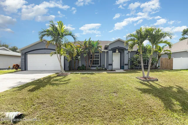 a house view with swimming pool in front of house