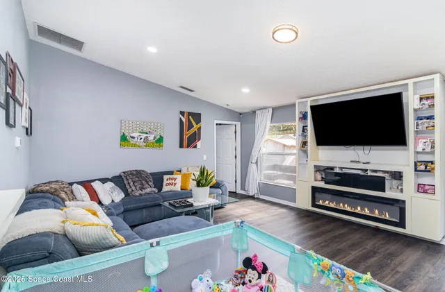 a living room with furniture and a flat screen tv