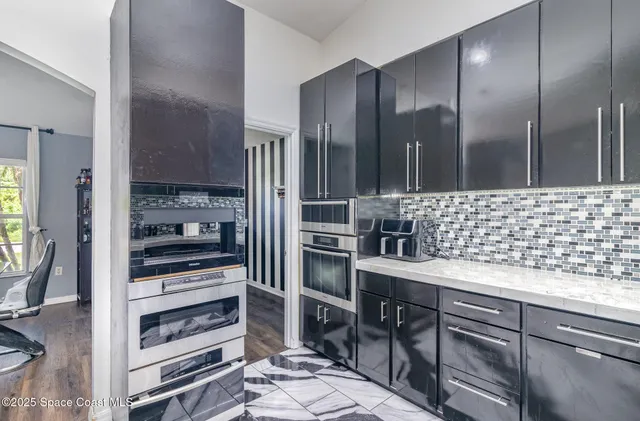 a kitchen with a refrigerator and a sink