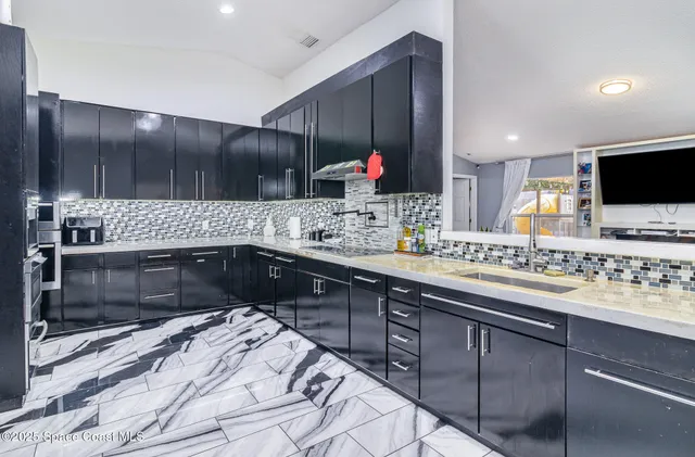 a kitchen with a sink stove and cabinets