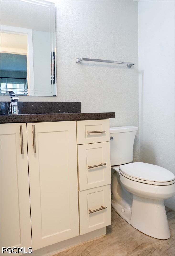 592 Fanshaw Way, Unit O Boca Raton, FL 33434 - Photo 13 of 25 a bathroom with a toilet and a sink