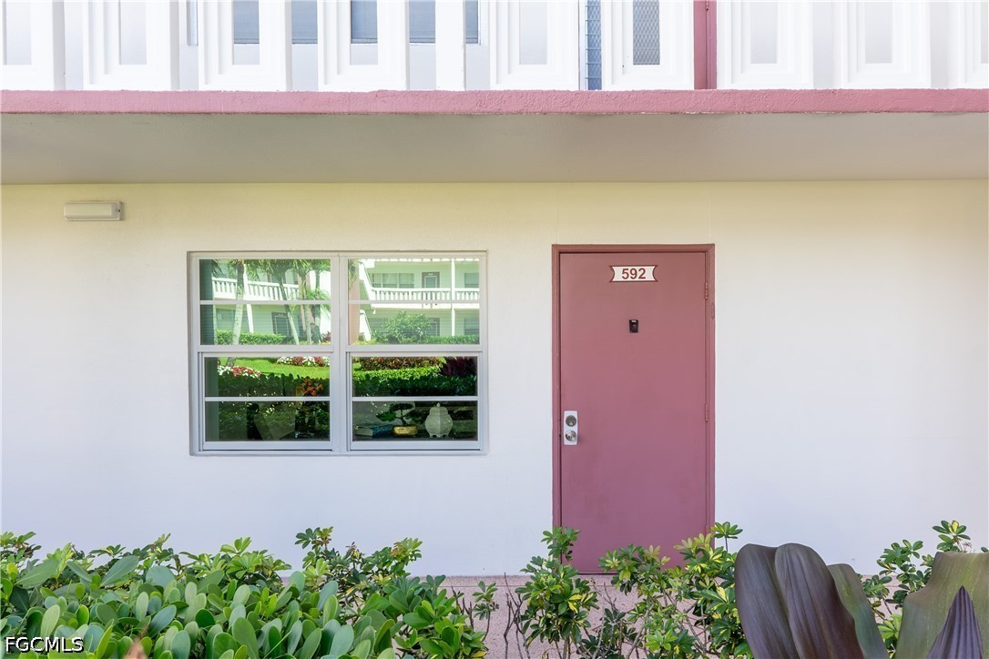 592 Fanshaw Way, Unit O Boca Raton, FL 33434 - Photo 16 of 25 a front view of a house with a yard