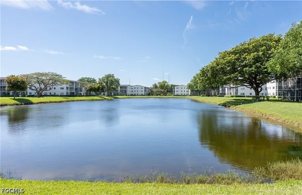 a view of a lake with houses in the background