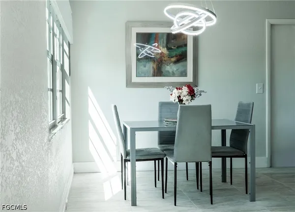 a dining room with furniture and chandelier