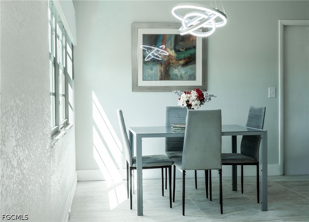 592 Fanshaw Way, Unit O Boca Raton, FL 33434 - Photo 5 of 25 a dining room with furniture and chandelier