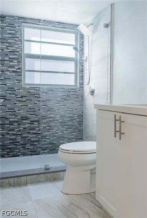 a bathroom with a toilet and a shower