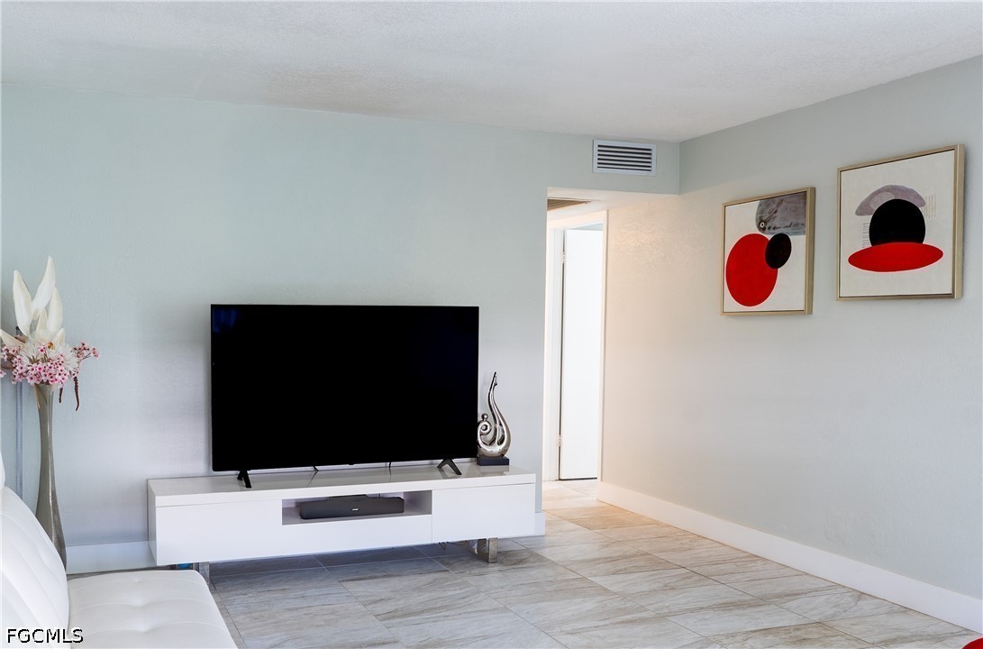 592 Fanshaw Way, Unit O Boca Raton, FL 33434 - Photo 8 of 25 a living room with furniture and a flat screen tv