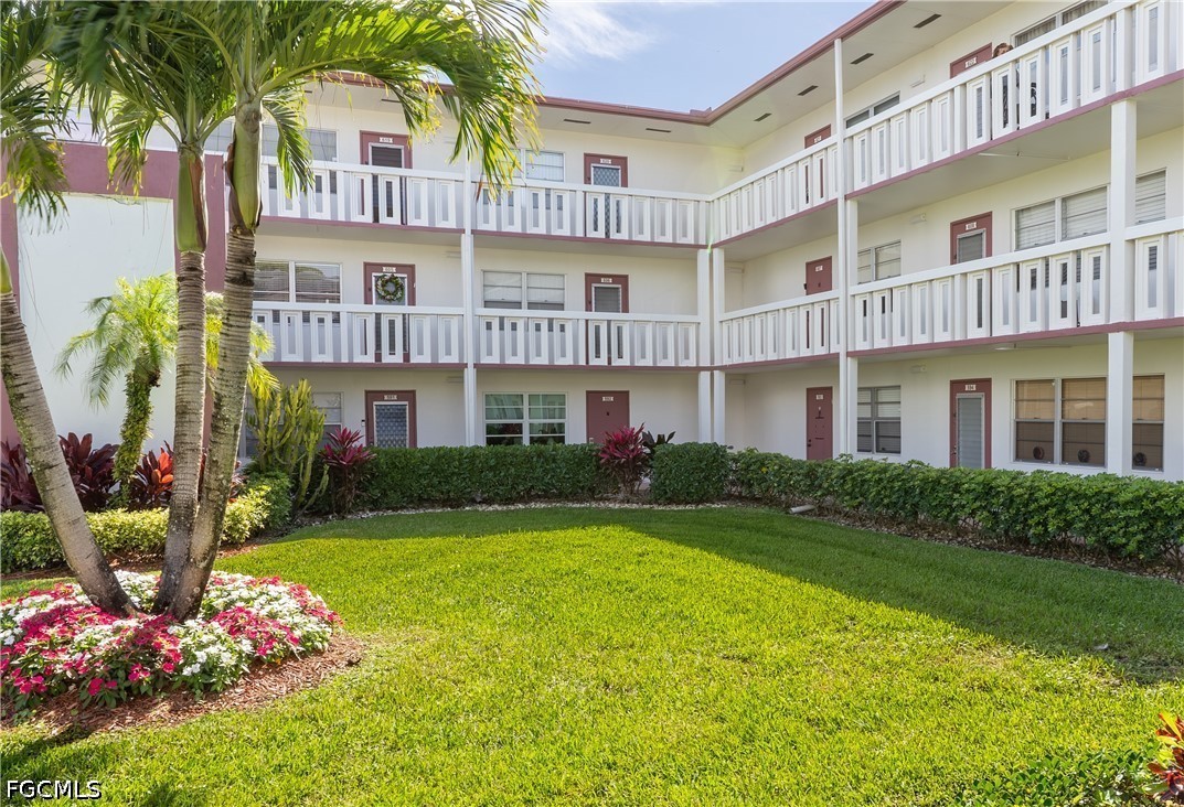 592 Fanshaw Way, Unit O Boca Raton, FL 33434 - Photo 9 of 25 a front view of a residential apartment building with a yard
