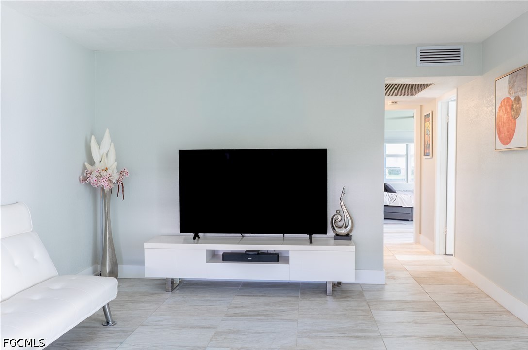 592 Fanshaw Way, Unit O Boca Raton, FL 33434 - Photo 10 of 25 a living room with furniture and a flat screen tv