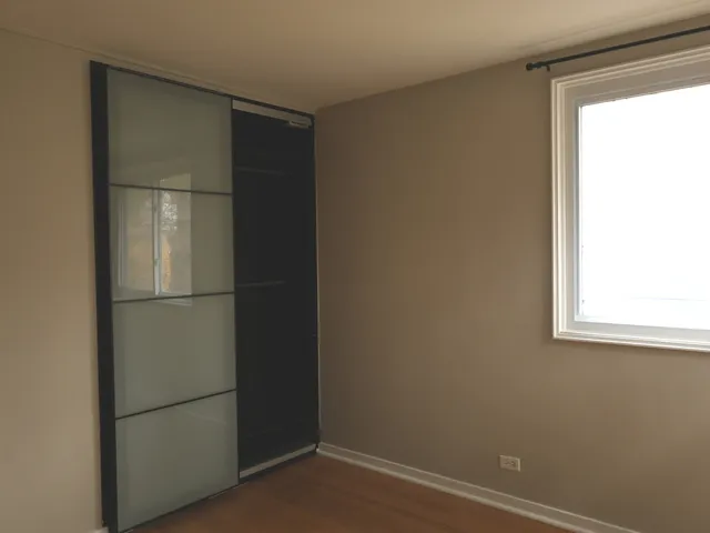 a room with closet and wooden floor