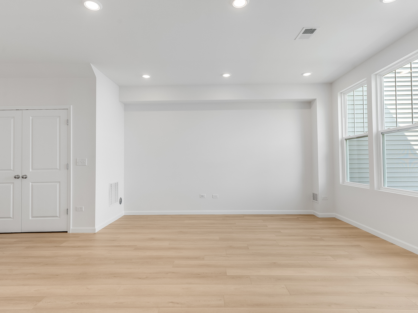 660 Switchgrass Way, Unit 58002 Bolingbrook, IL 60490 - Photo 11 of 24 a view of an empty room with wooden floor and a window