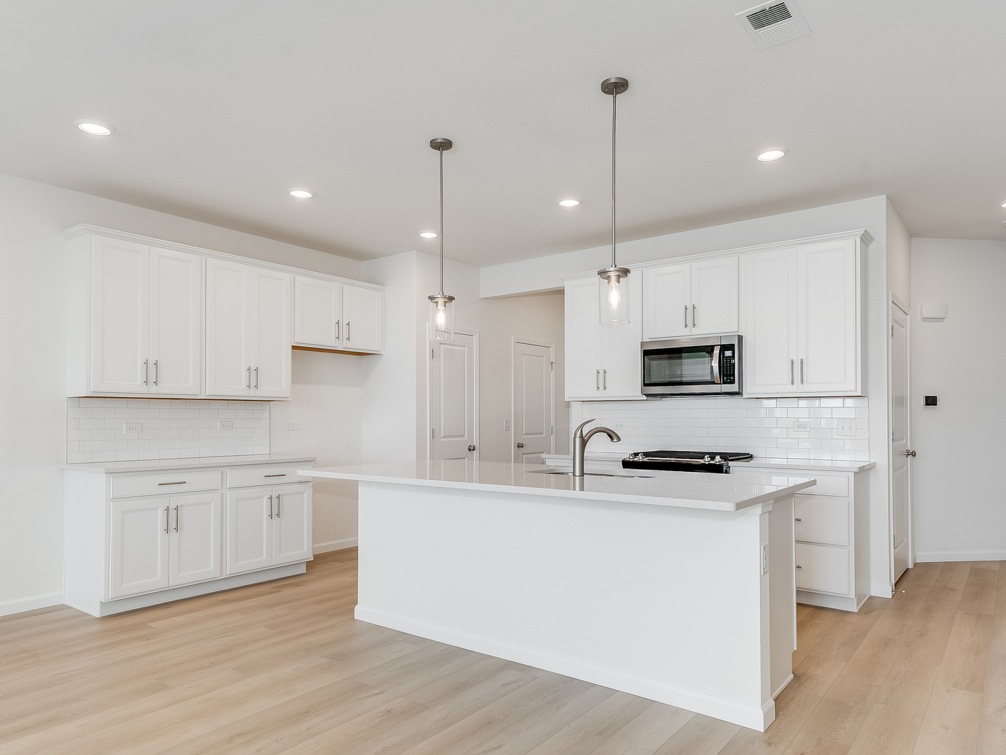 660 Switchgrass Way, Unit 58002 Bolingbrook, IL 60490 - Photo 3 of 24 a kitchen with stainless steel appliances granite countertop a sink a stove a refrigerator and white cabinets with wooden floor
