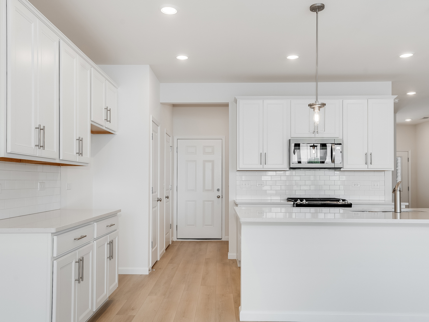 660 Switchgrass Way, Unit 58002 Bolingbrook, IL 60490 - Photo 7 of 24 a kitchen with stainless steel appliances granite countertop a sink and a refrigerator