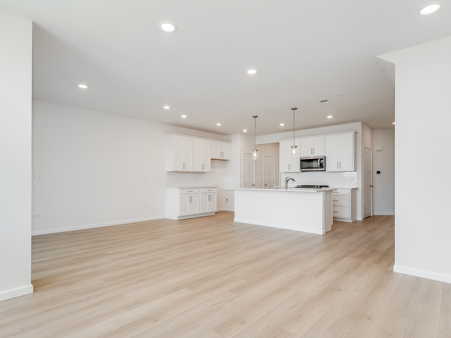 660 Switchgrass Way, Unit 58002 Bolingbrook, IL 60490 - Photo 10 of 24 a view of kitchen with white cabinets and stainless steel appliances