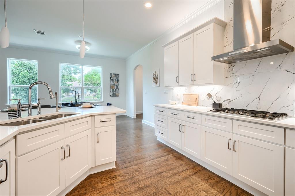 3101 Raphael Court McKinney, TX 75070 - Photo 12 of 40 a kitchen with cabinets appliances a sink and a window
