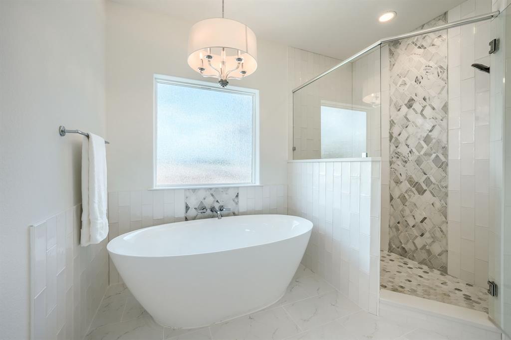 3101 Raphael Court McKinney, TX 75070 - Photo 31 of 40 a bathroom with a bathtub and shower
