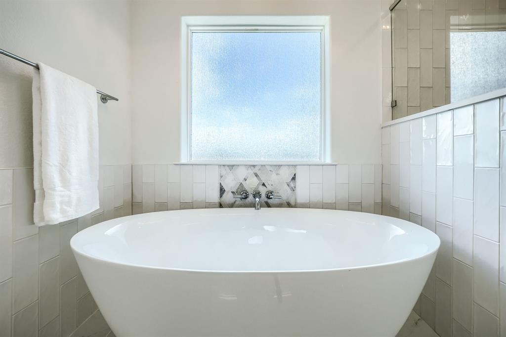 3101 Raphael Court McKinney, TX 75070 - Photo 32 of 40 a white tub sitting in a bathroom