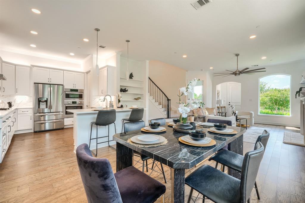 3101 Raphael Court McKinney, TX 75070 - Photo 6 of 40 a view of a dining room and livingroom with lots of furniture and wooden floor