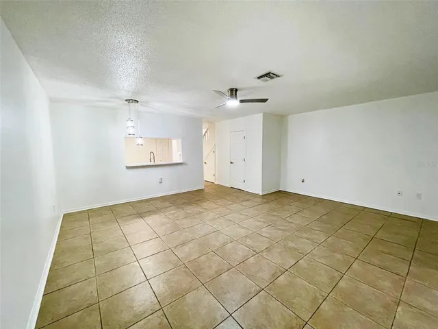a bathroom with a toilet sink vanity granite and shower