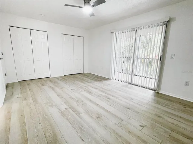 a view of an empty room with kitchen