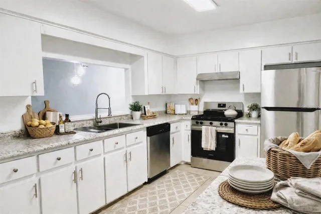 a kitchen with a sink appliances and cabinets
