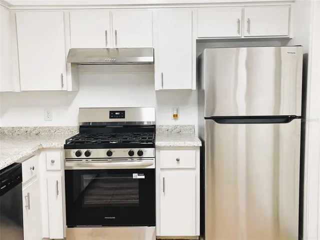 a living room with furniture a chandelier and a dining room