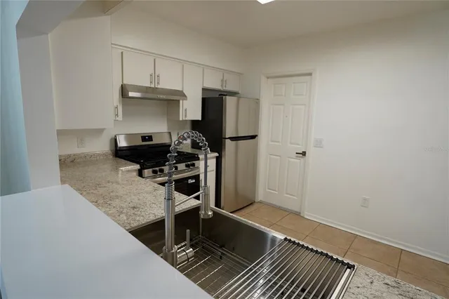 a bathroom with a granite countertop sink and mirror