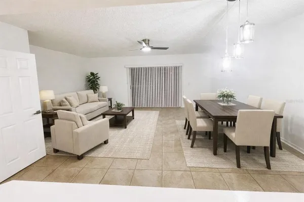 an empty room with wooden floor ceiling fan and windows