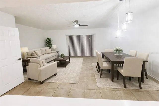 an empty room with wooden floor ceiling fan and windows