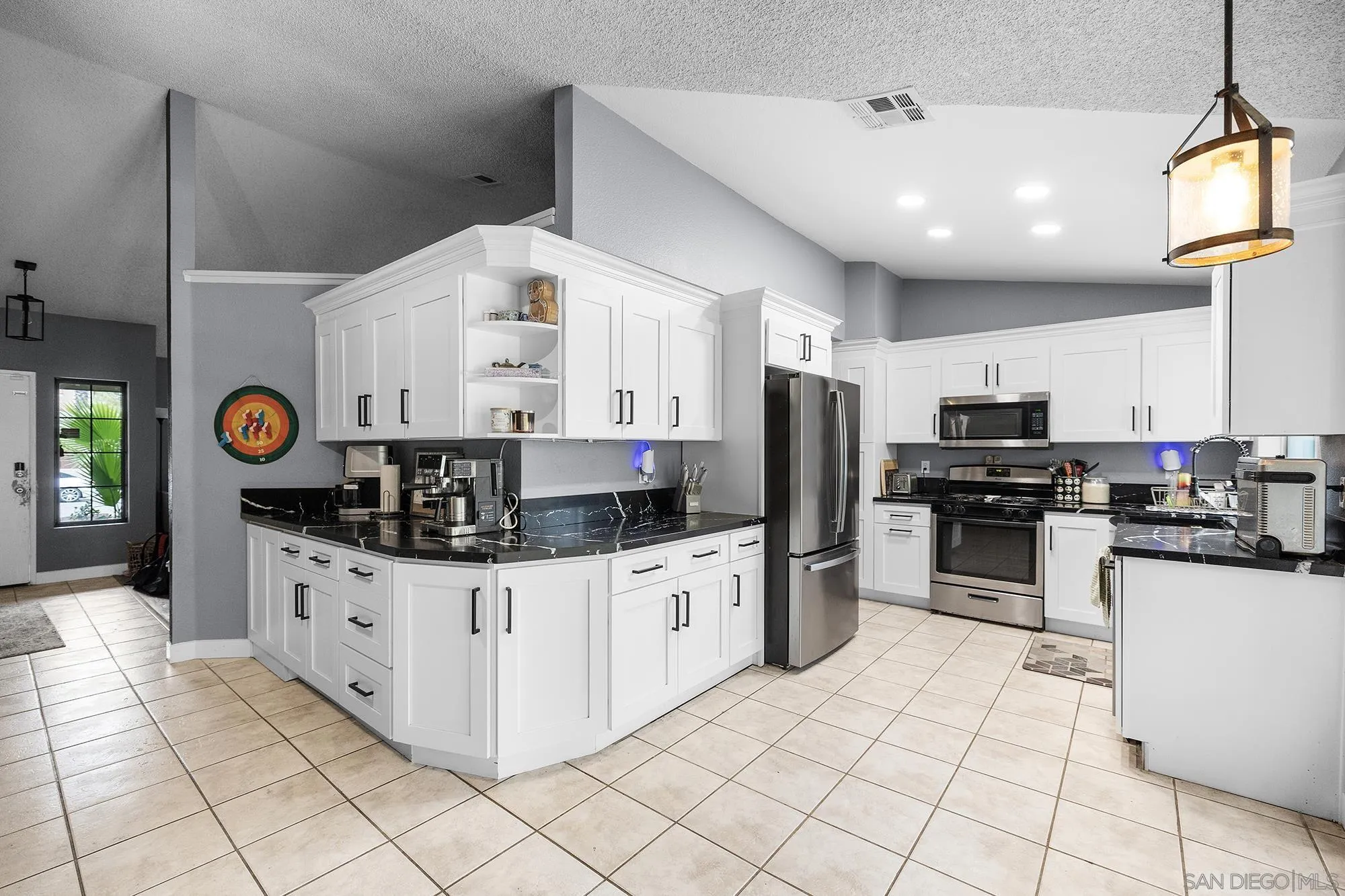 31297 Huron Street Temecula, CA 92592 - Photo 11 of 42 a kitchen with stainless steel appliances kitchen island granite countertop a stove and a sink