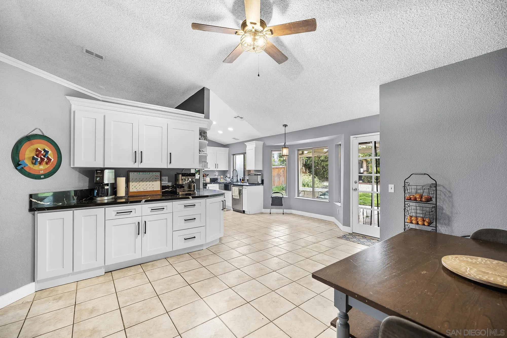31297 Huron Street Temecula, CA 92592 - Photo 15 of 42 a kitchen with stainless steel appliances granite countertop a stove a sink dishwasher and a refrigerator with white cabinets