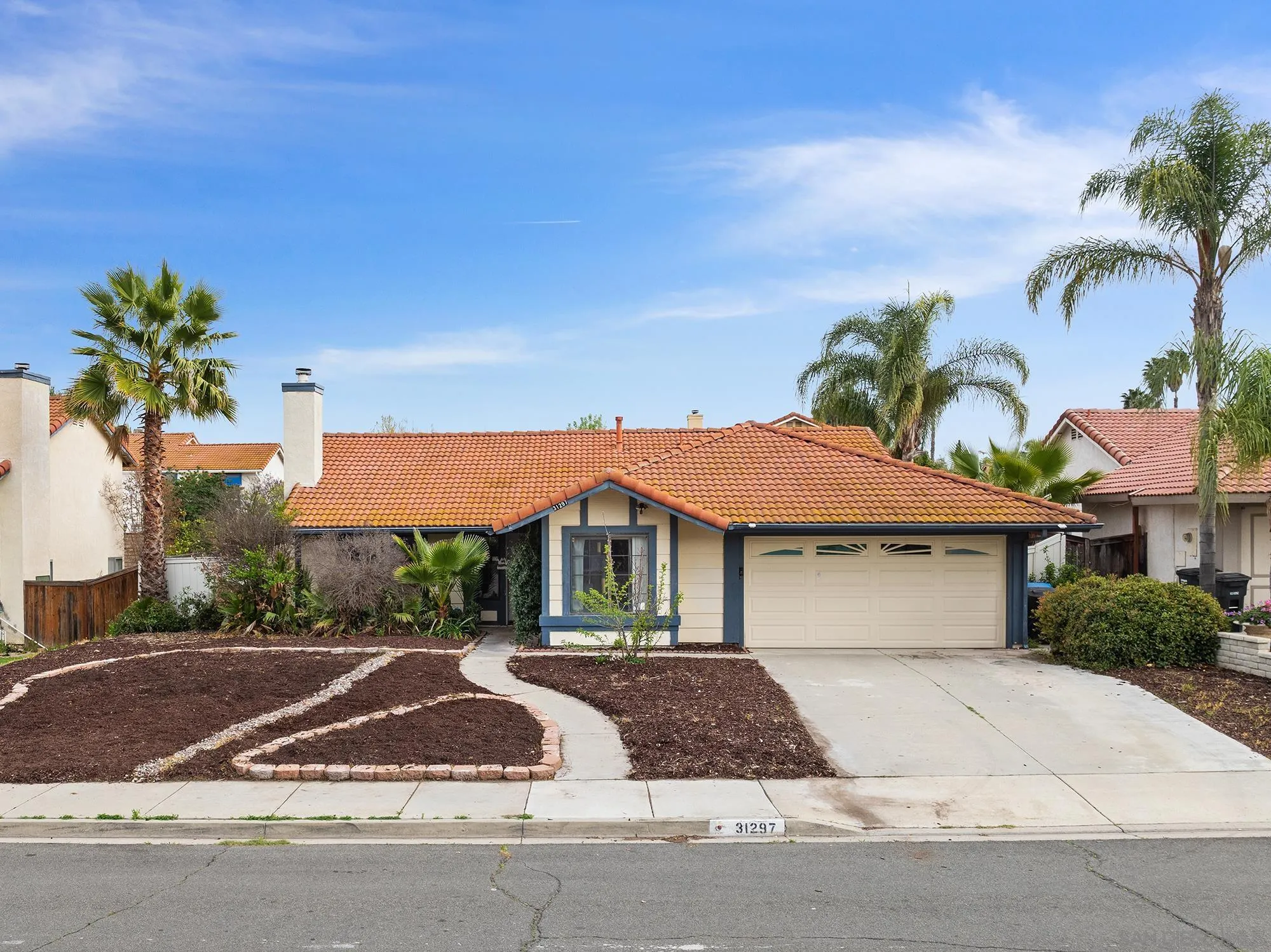 31297 Huron Street Temecula, CA 92592 - Photo 2 of 42 a front view of a house with a yard and garage