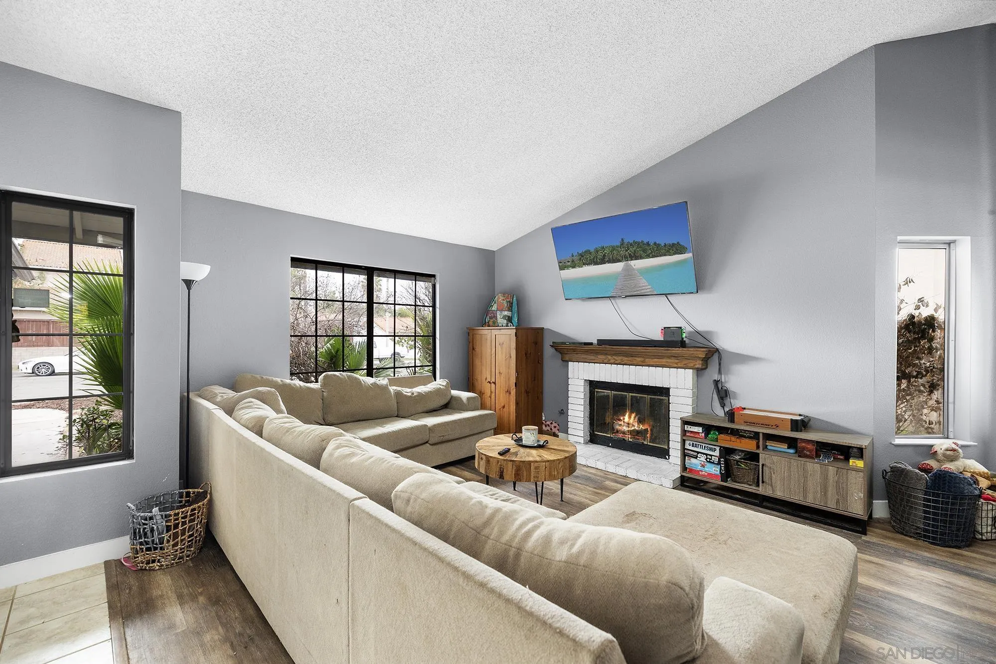 31297 Huron Street Temecula, CA 92592 - Photo 4 of 42 a living room with furniture a fireplace and a large window