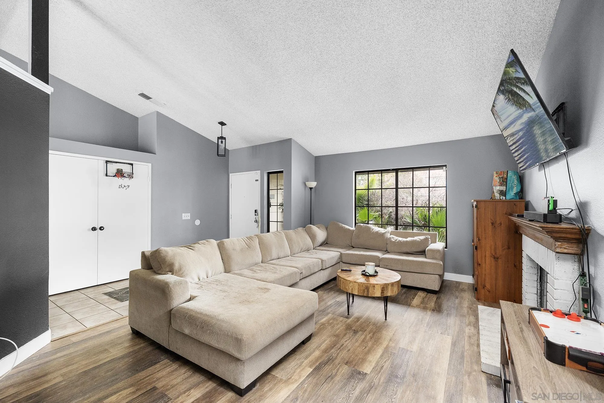 31297 Huron Street Temecula, CA 92592 - Photo 5 of 42 a living room with furniture a rug a window and a flat screen tv