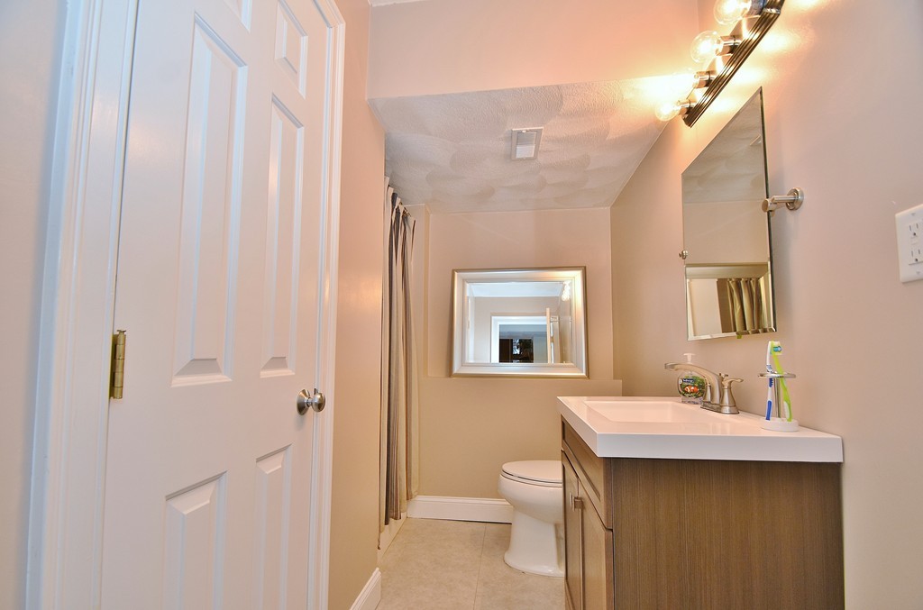 48 Partridge Road Billerica, MA 01821 - Photo 17 of 19 a bathroom with a sink a mirror and a toilet