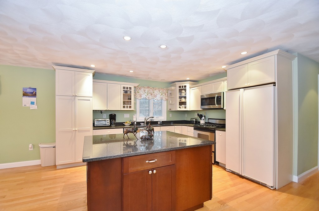 48 Partridge Road Billerica, MA 01821 - Photo 2 of 19 a kitchen with stainless steel appliances granite countertop a sink stove and refrigerator