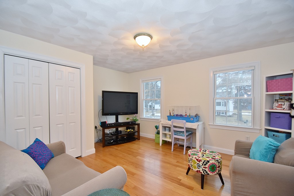 48 Partridge Road Billerica, MA 01821 - Photo 8 of 19 a living room with furniture and a flat screen tv with kitchen view