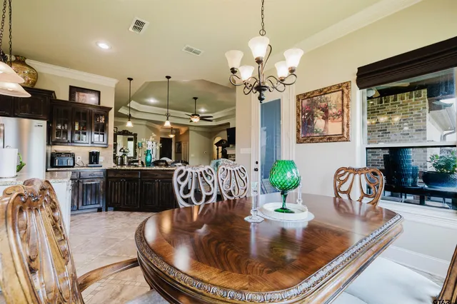 a dining room with furniture and chandelier