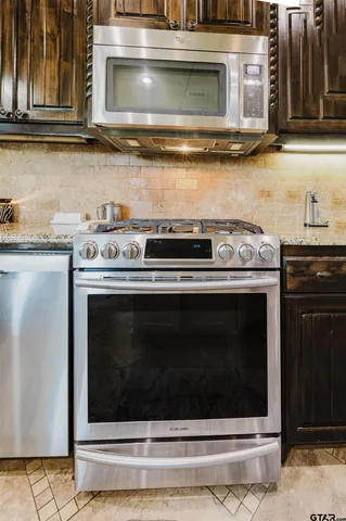 a stove top oven sitting inside of a kitchen