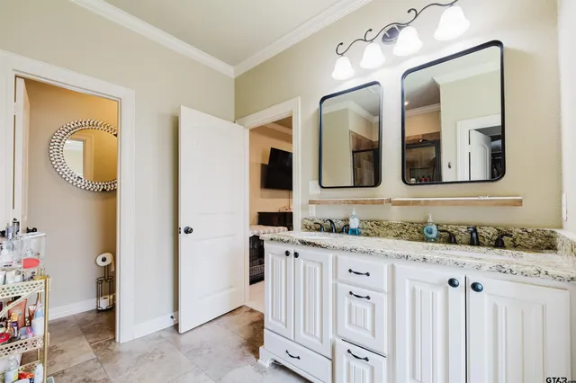 a bathroom with a double vanity sink a mirror and a bathtub
